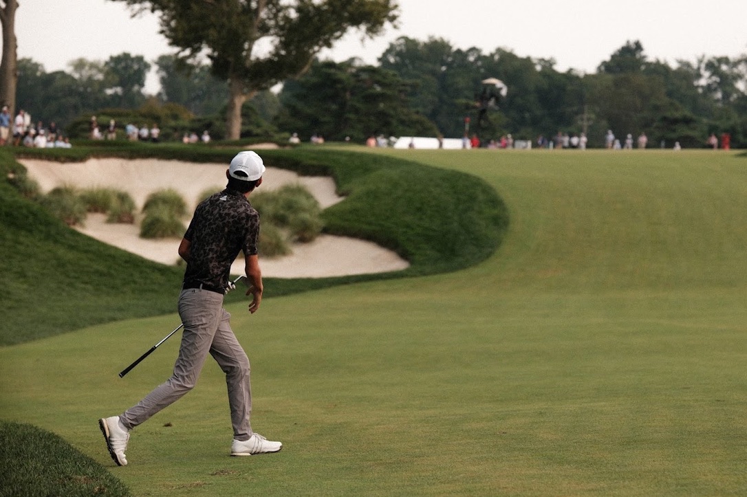 Jay Leng watching a golf shot toward the green