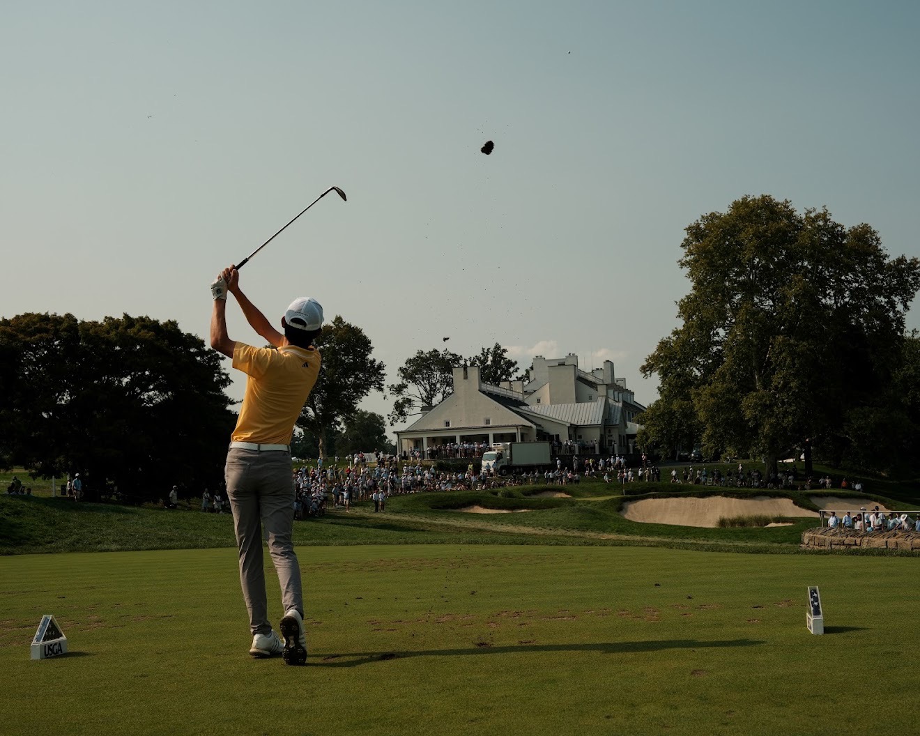Jay Leng watching an approach shot toward a clubhouse