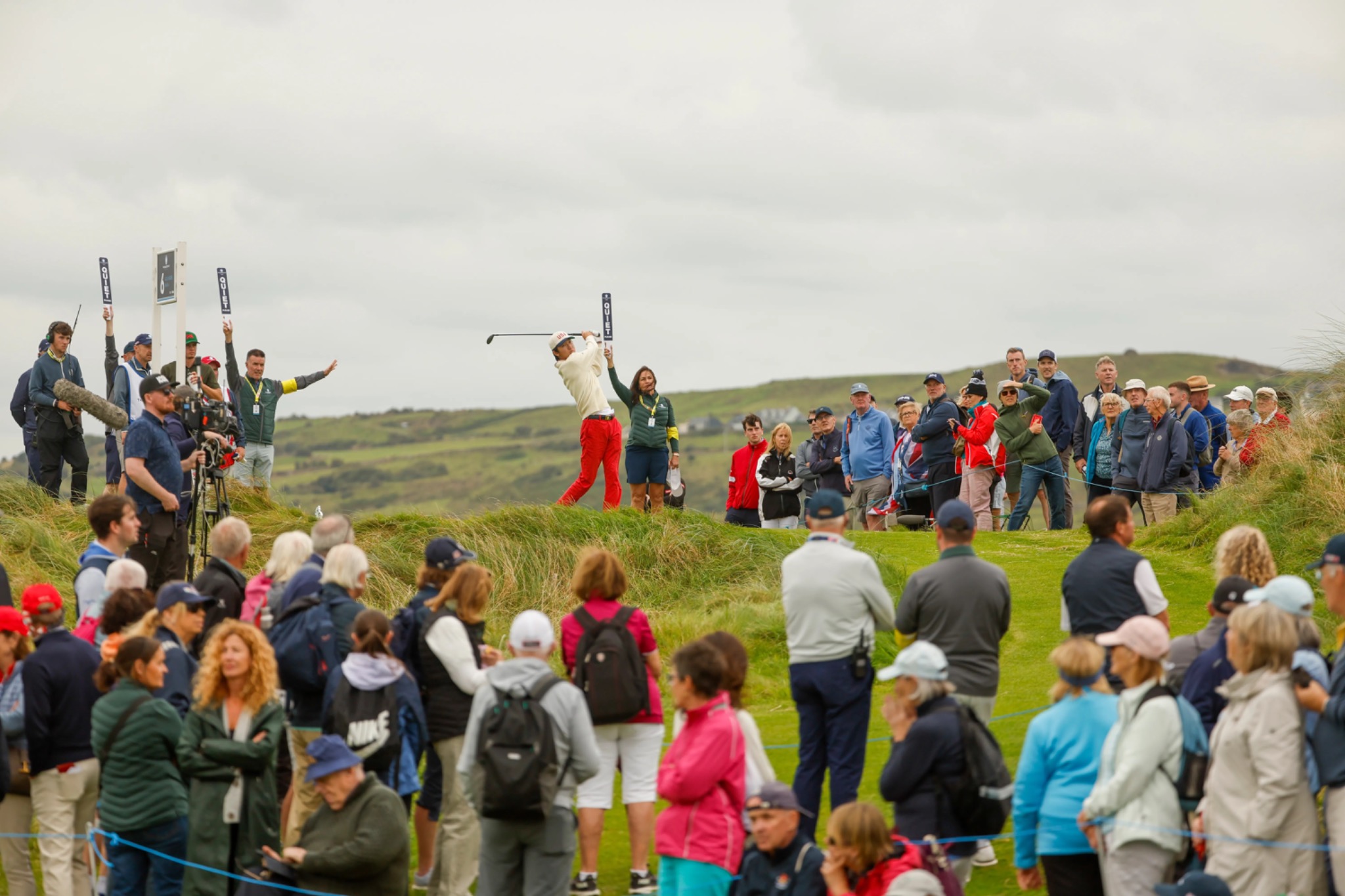 Jay Leng hitting a golf shot in front of a large gallery