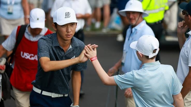 Jay Leng greeting a young fan at a tournament