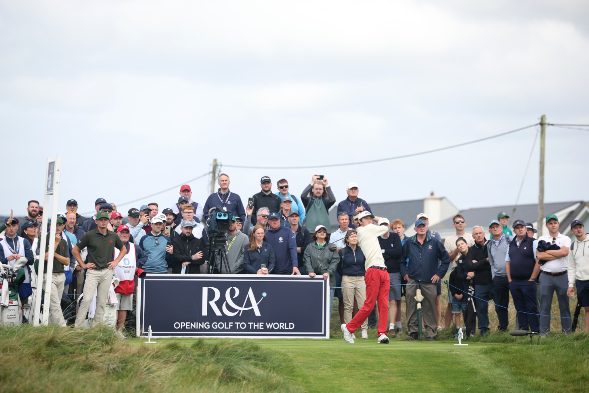 Jay Leng swinging on a links course in front of a large crowd