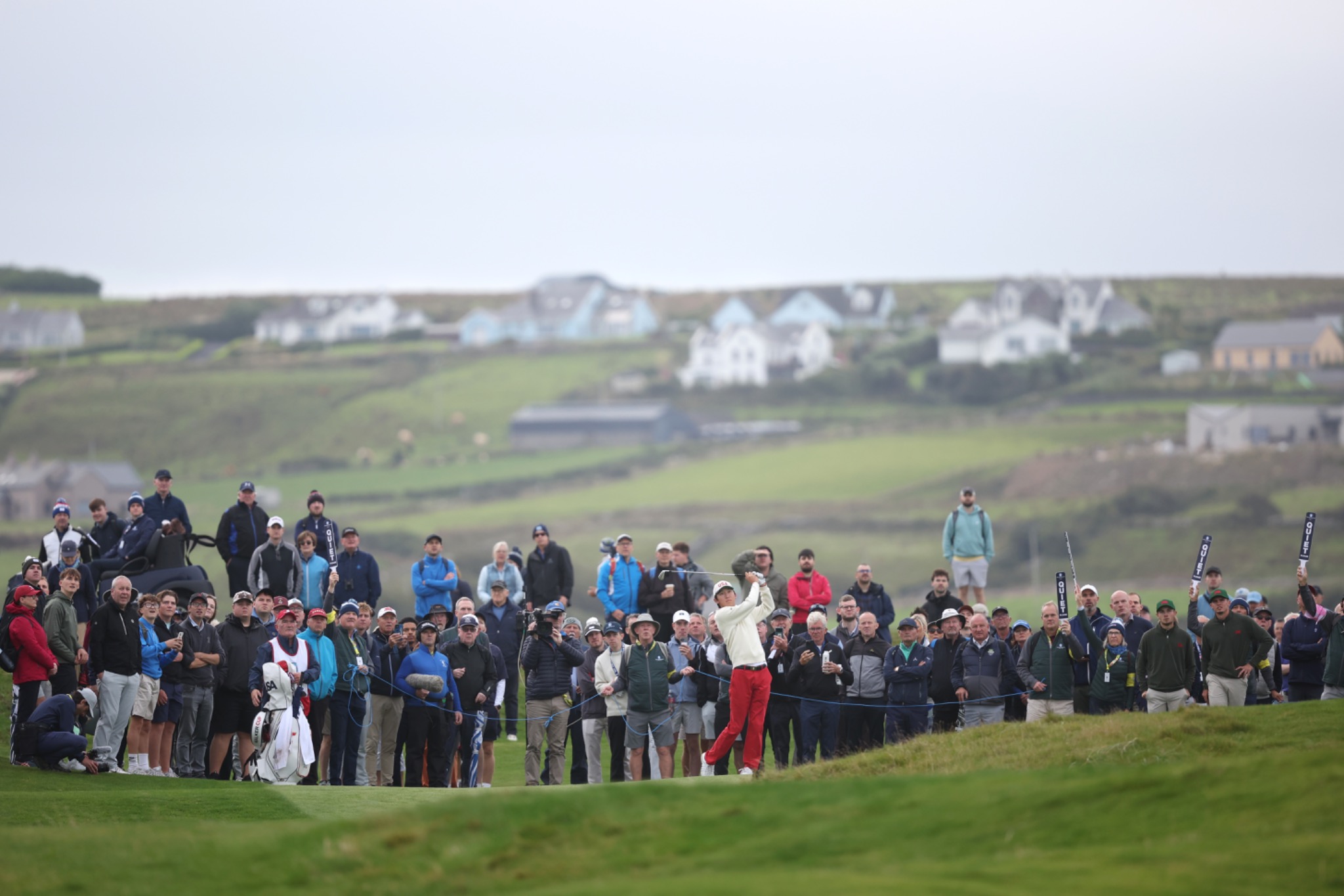 Jay Leng hitting a tee shot beside R and A signage